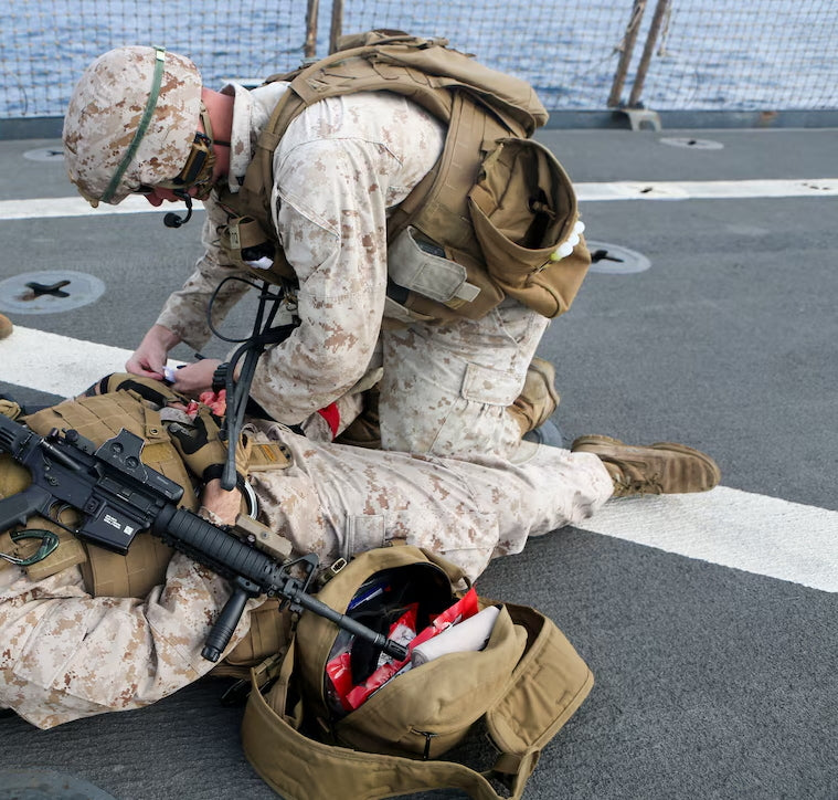 Shipboard medical personnel conducting emergency trauma response drill on vessel deck