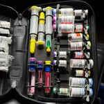 Close view of the included LARGE PFC Medication Panel loaded with simulated training vials and prefilled syringes. The small panel visible at left is a separately sold NARCO Panel and is not included. Medications not included.