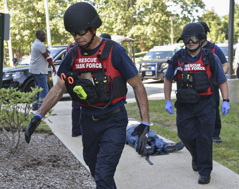 Rescue Task Force firefighter wearing blue nitrile gloves at emergency scene
